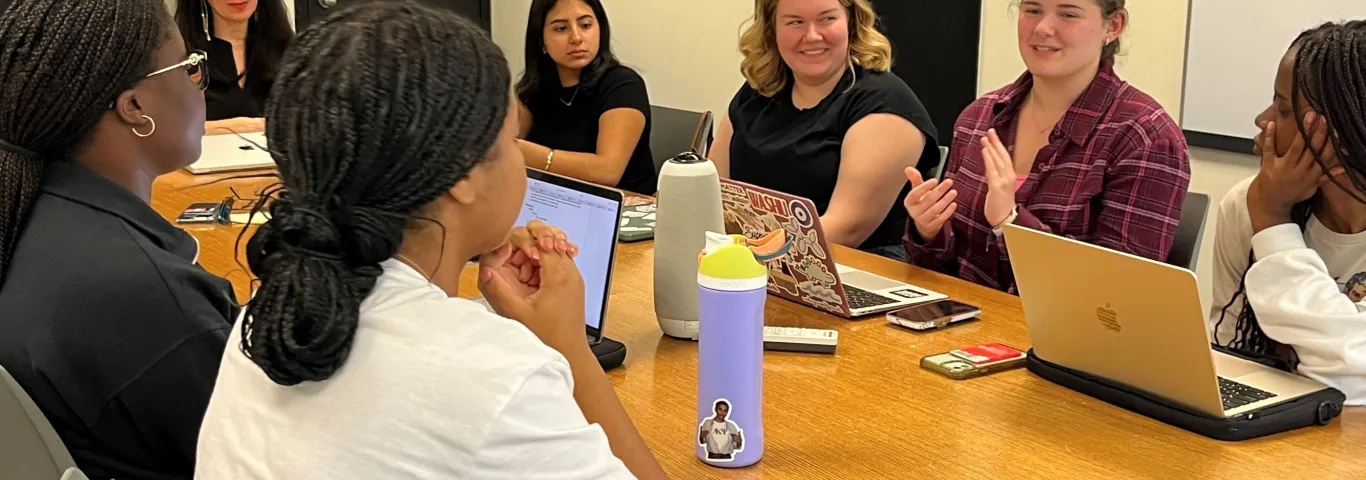 students conversing in a seminar room