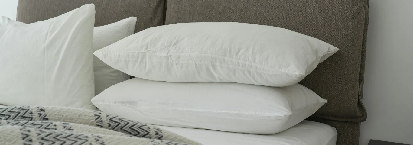 photo of a bed piled with pillows