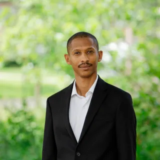 Mohammed Abba-Aji says the experience of leading a military medical team charged with providing care for a community of displaced people led him toward the field of public health. Now a postdoctoral researcher and population health scientist, he uses complex systems science to study what drives health outcomes at the population level. (Photo: Zachary Linhares/WashU Bursky Public Health) 