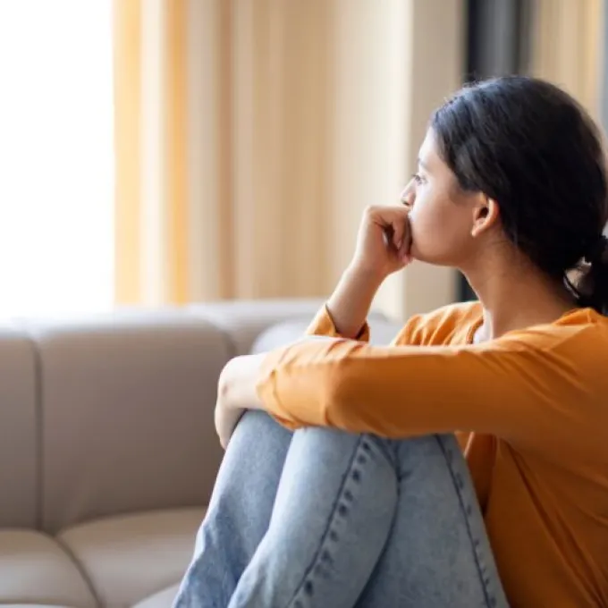 A young adult sits alone at home. New research from WashU School of Public Health explores how social connection relates to depression and anxiety. (Photo: Shutterstock)