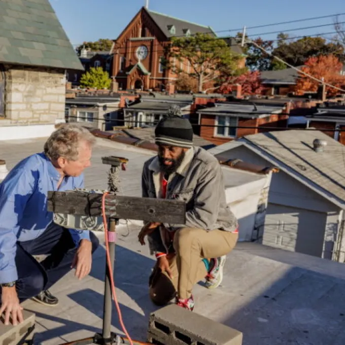 Tyler Cargill (right), a recent PhD graduate of WashU McKelvey Engineering, looks over air monitoring equipment on a roof in south St. Louis with his adviser, Jay Turner, the James McKelvey Professor of Engineering Education. Turner’s lab will collaborate with the city to do similar air monitoring as tornado cleanup continues. (Photo: Whitney Curtis/WashU)