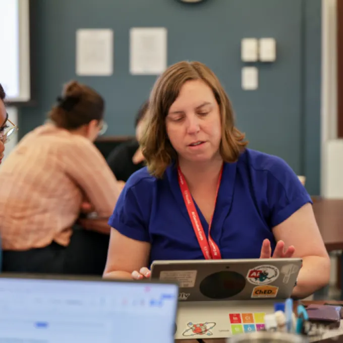 WashU student Selah Pabon (left) consults with Janie Brennan, associate chair of undergraduate studies and a teaching professor at McKelvey Engineering, during this summer's AI Curriculum Corps. (Photo: Carter Staley)